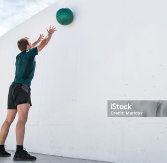 a man reaching up to catch a ball