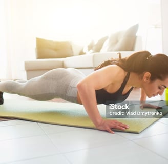 a woman doing push ups on a yoga mat