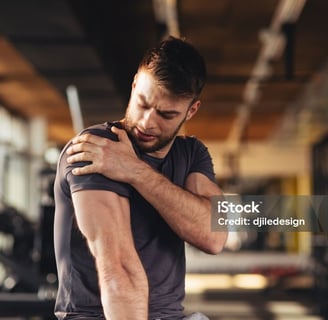 a man with a tattoo on his arm and arm holding tight muscles