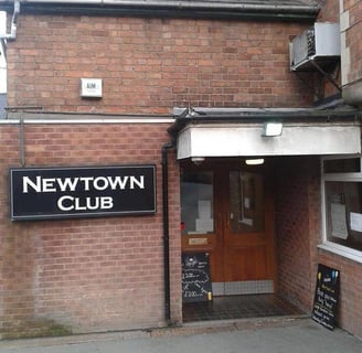 a sign that says new town club