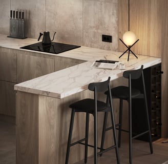 a kitchen with a marble counter top and bar stools