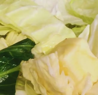 chunk of butter on top of chopped up raw cabbage