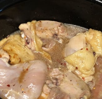 Carolina pulled chicken in slow cooker with spices and sauce