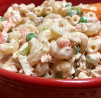 Chilled tuna pasta salad with carrots in a red serving bowl, simple and budget-friendly meal