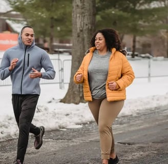 Plus-size woman jogging with a thinner man in the snow, showing real-life movement for weight loss in winter