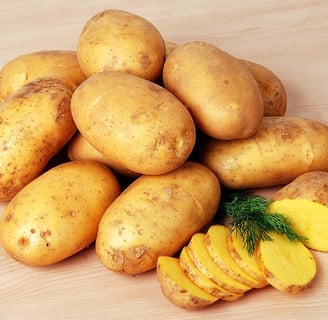 sliced potatoes with whole yellow potatoes