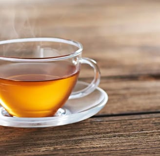 A warm cup of tea sitting on a wooden table, capturing the feeling of a quiet moment shared at home