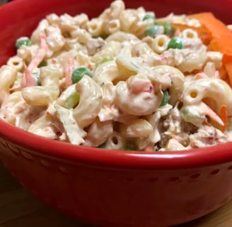 Finished tuna pasta salad in a red bowl ready to serve