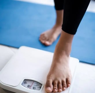 bathroom scale with feet stepping on .