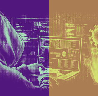a person in a hoodie is sitting at a laptop