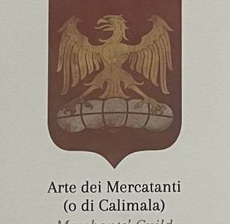 a medieval guild emblem with an eagle on a bale of cloth