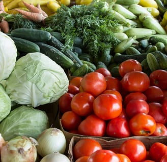 a variety of vegetables and fruits are displayed in a variety of baskets
