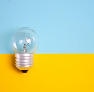 a light bulb bulb in a light bulb bulb on a yellow and blue background