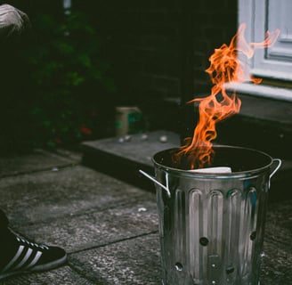 a person sitting on a bench in front of a fire