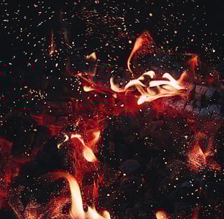 a fire burns in the night sky