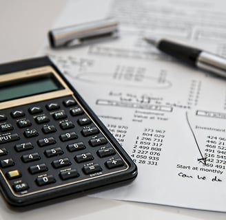 a calculator and pen on a paper with a pen