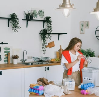 a woman in a red vest and white shirt is standing in a kitchen
