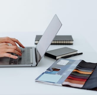 a person typing on a laptop computer