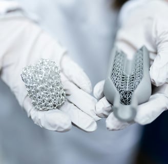 a person in white gloves holding materials to make batteries
