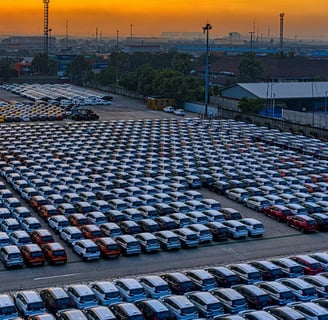 a parking lot full of electric cars parked in a parking lot