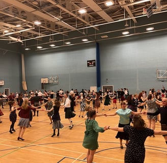 Dancers in a gymnasium, dancing circles