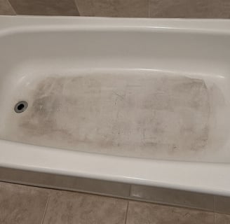 Bathtub before renovation for a restore and list your home project in DC, showing grime and wear pri