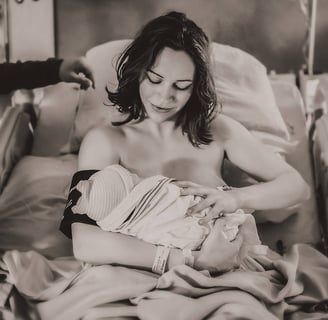 Mama holding her baby in the hospital bed right after birth