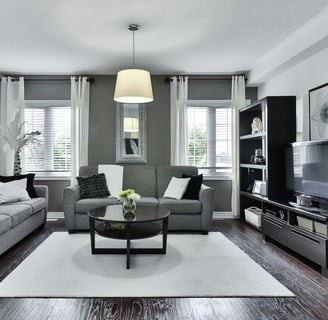 Cozy living room with velvet sofas and pendant light, featured by Regal Touch Home.