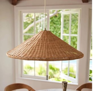Woven rattan pendant light in a cozy dining area, featured by Regal Touch Home.