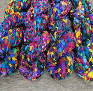 Braided recycled sari silk ribbon yarn. 10-12 meters of ribbon in 100 gram skein