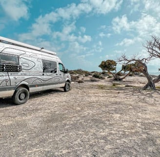 a van parked on a rocky beach