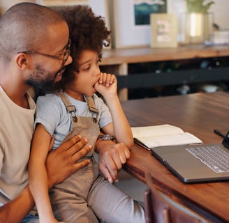 father and child talking to a health practitioner via telehealth