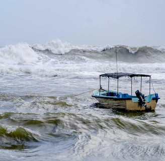 A ship anchored in with large waves incoming.