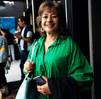 a woman in a green shirt and a green purse