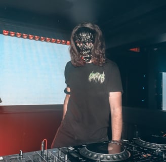 a man in a black shirt and a dj booth