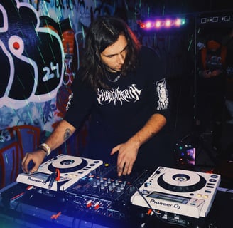 a man in a black shirt is playing a dj - Creechur