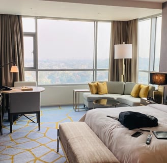 A hotel room with a couch and a television used for a blog titled AI hotel marketing