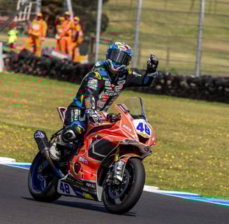 a person riding a motorcycle on a track