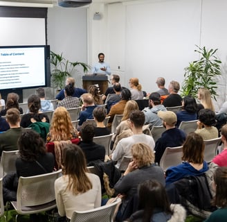 A design professional delivering a talk at a design conference