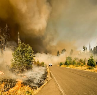 a car driving down a road with a lot of smoke