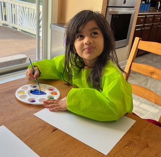 Photo of young child painting at the daycare.