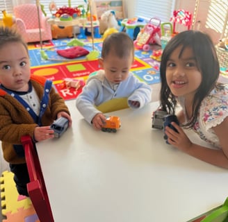 Photo of three young children playing in the daycare.