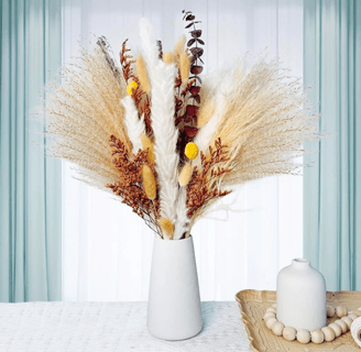 a vase with dried flowers 