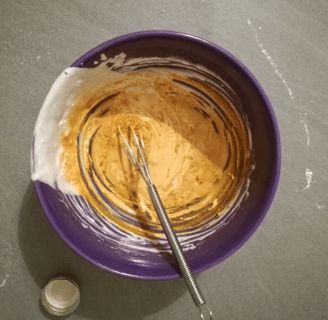 a bowl of food with a whisk
