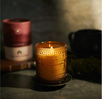 a fall scented candle in a glass candle holder