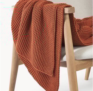 a chair with a blanket on it 