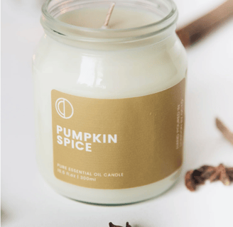 a pumpkin spice candle that is sitting on a table