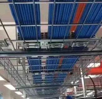 a large room with a lot of blue cables on the wire mesh cable tray