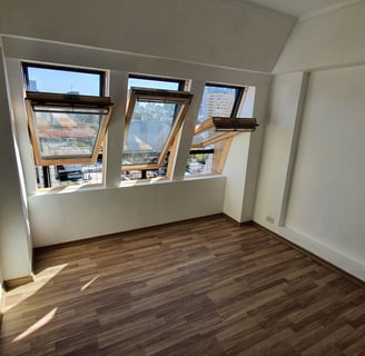 a room with a window and a wooden floor