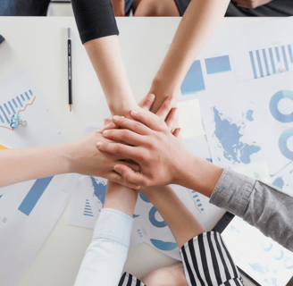 a group of people holding hands together in a circle